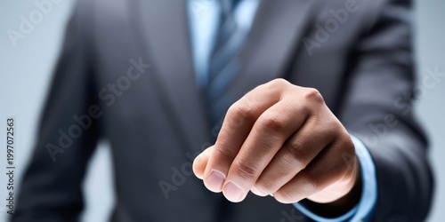 Businessman in suit holding out hand, offering something invisible or intangible
