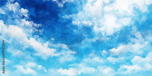 A beautiful bright blue summer sky features fluffy white cumulus clouds across a clear sunny atmosphere for a peaceful nature background