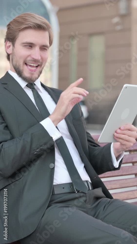 Online Video Chat on Tablet by Businessman Sitting Outdoor on Bench, Vertical Video
