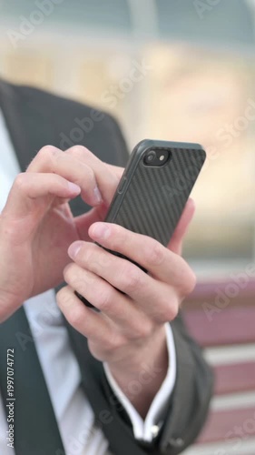 Close Up of Businessman Using Smartphone while Sitting Outdoor on Bench, Vertical Video