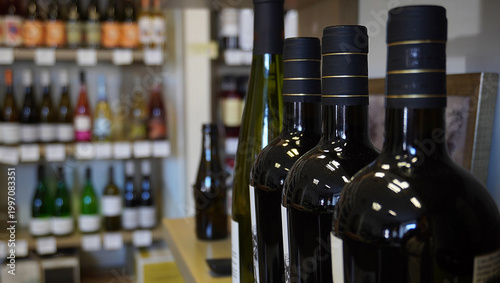 Wine shop interior with bottles on display, selective focus and copy space.