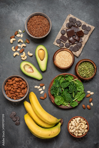 Various products containing magnesium on dark grunge background. Top view, copy space.