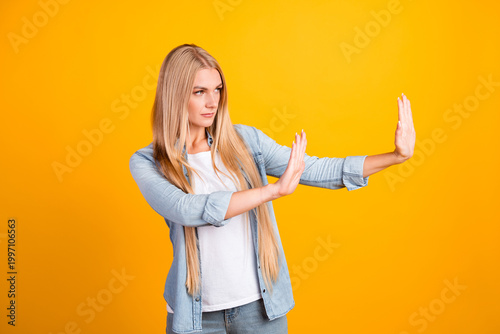 Εκτύπωση καμβά Young woman making stop gesture and setting a boundary while pushing away with h