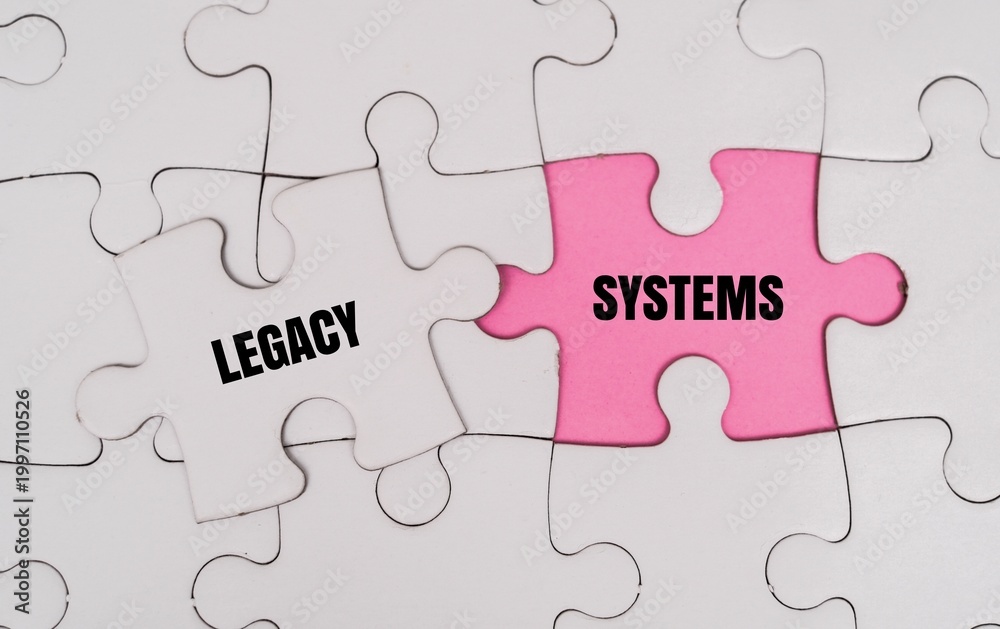 Fototapeta premium LEGACY, SYSTEM word alphabet letters on puzzle. Symbolizing the challenge of integrating, updating, or replacing outdated technology within a modern corporate infrastructure