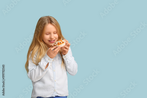 Cute little girl with tasty...