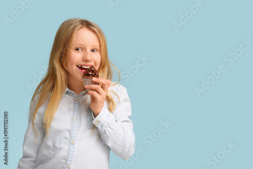Cute little girl eating swe...