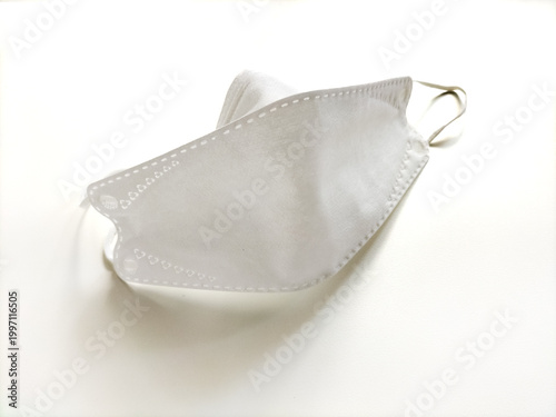 White face mask with a structured, contoured design and elastic ear loops. Typical of masks used for respiratory protection in healthcare and public settings.