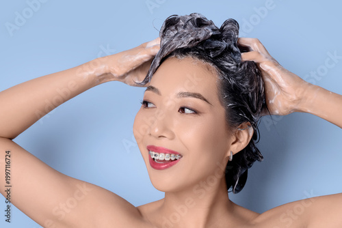 Young Asian woman applying ...