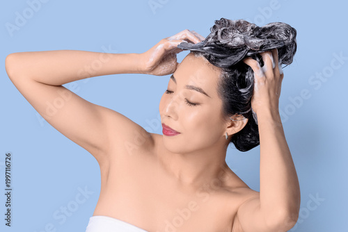 Young Asian woman applying ...