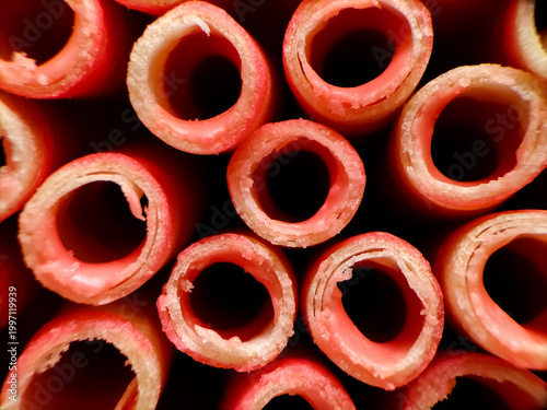 Close-up view of multiple wafer roll cookies arranged vertically.