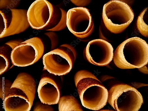 Cylindrical wafer rolls cookies, are shown closely packed. 