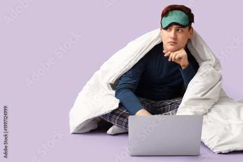 Handsome young man with bed...