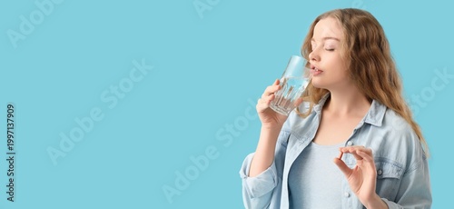 Young woman taking vitamins...