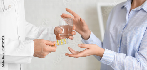 Male doctor giving pills an...