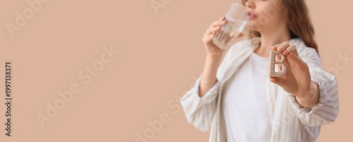 Young woman taking vitamin ...