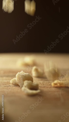 Bread crumbs falling on a wooden board