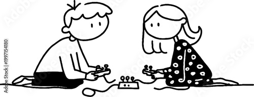 Two children playing video game controllers on floor