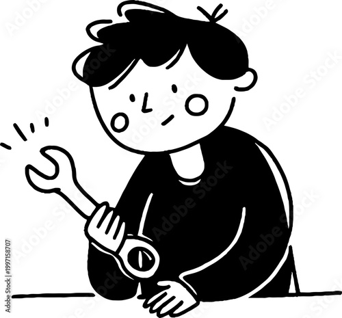 Teenager examining wrench while seated at worktable