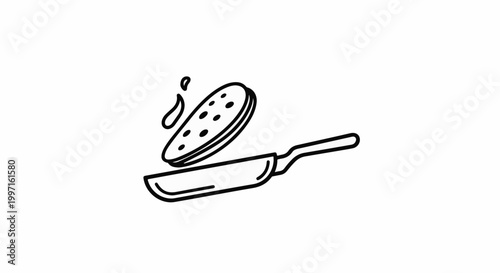 A pancake with holes is flipped in a pan with oil drops