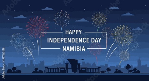 Graphic illustration of a city skyline with fireworks and 'HAPPY INDEPENDENCE DAY NAMIBIA' text on a dark blue night sky with clouds.
