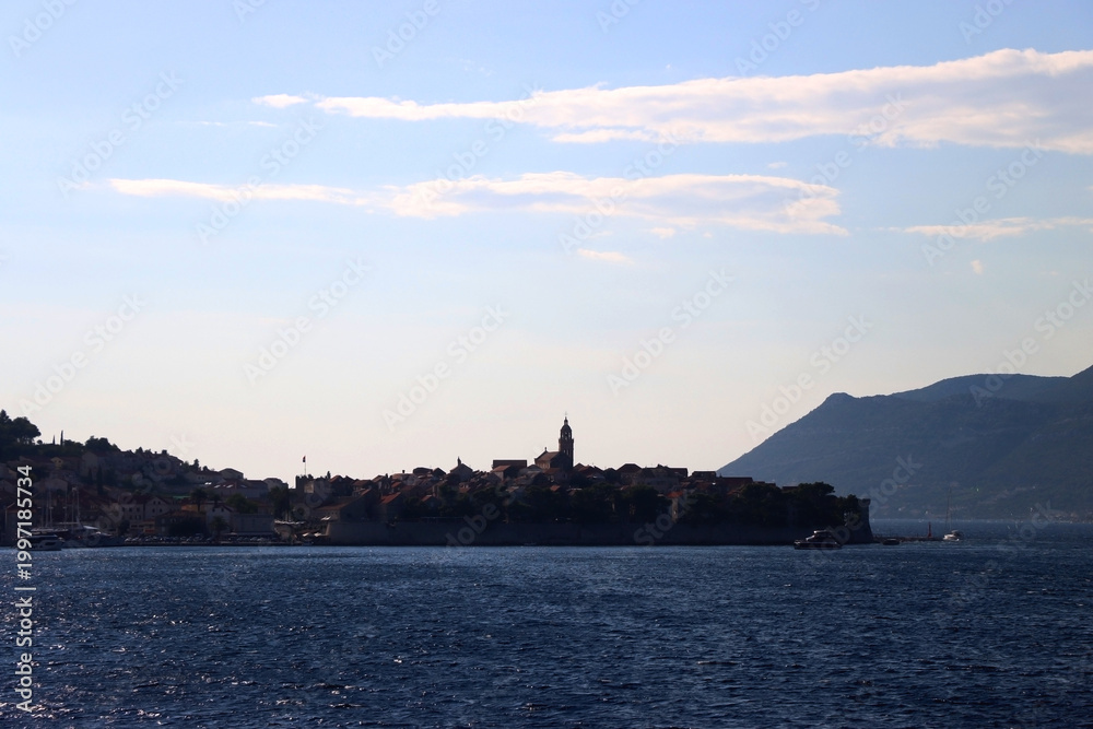Naklejka premium Small town Korcula, on island Korcula, Croatia, illuminated by back light. Summer travel destination.