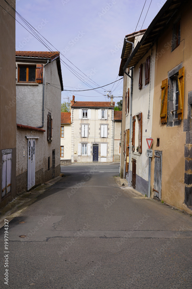 Fototapeta premium Narrow street in French village with traditional houses and quiet residential view