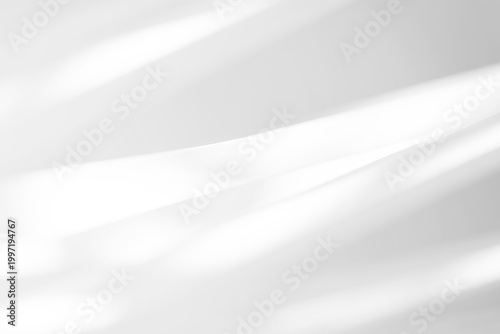 Minimal abstract background with soft flowing light and shadow creating a smooth gradient effect. Clean neutral surface with gentle wave-like shapes, perfect for modern design, branding, presentations