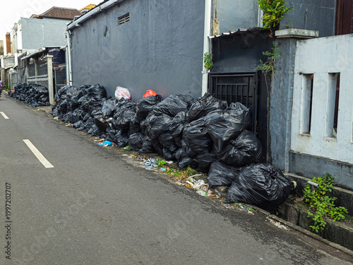 Tableau sur toile Large piles of garbage along a roadside in Bali, Indonesia, showing pollution, waste management issues, and the need for sustainable solutions and stronger public awareness
