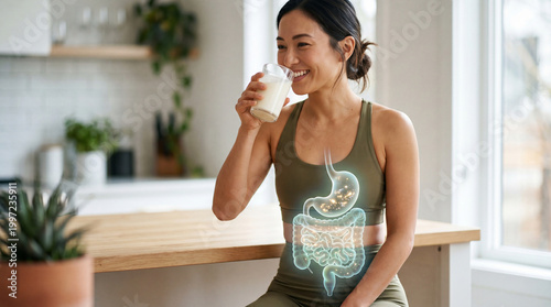 A radiant woman enjoys a nutritious drink while a glowing illustration highlights the digestive system, a compelling visual that celebrates health. 