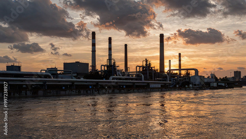 Industrial Riverside Skyline at Sunset with Dramatic Clouds