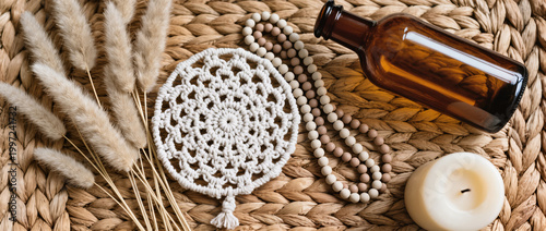 Boho Decor Flatlay with Macrame Coaster, Pampas Grass, Amber Glass Bottle, Ceramic Beads and Neutral Candle on Woven Rattan in Soft Natural Light
