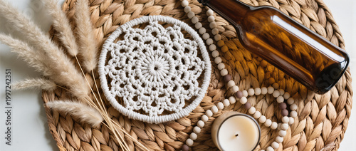 Boho Decor Flatlay with Macrame Coaster, Pampas Grass, Amber Glass Bottle, Ceramic Beads and Neutral Candle on Woven Rattan in Soft Natural Light