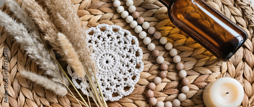 Boho Decor Flatlay with Macrame Coaster, Pampas Grass, Amber Glass Bottle, Ceramic Beads and Neutral Candle on Woven Rattan in Soft Natural Light