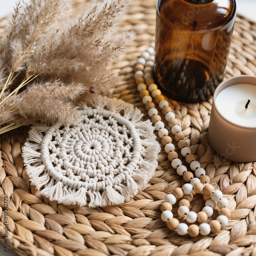 Boho Decor Flatlay with Macrame Coaster, Pampas Grass, Amber Glass Bottle, Ceramic Beads and Neutral Candle on Woven Rattan in Soft Natural Light