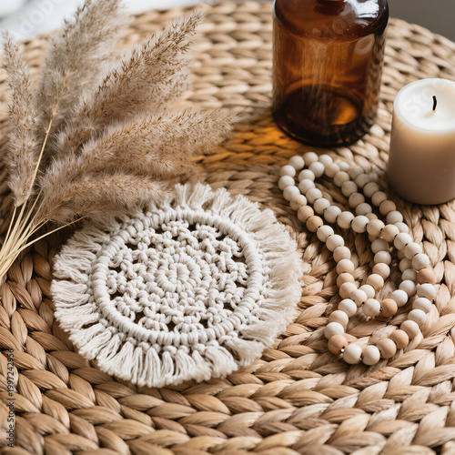 Boho Decor Flatlay with Macrame Coaster, Pampas Grass, Amber Glass Bottle, Ceramic Beads and Neutral Candle on Woven Rattan in Soft Natural Light