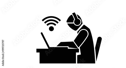 Man wearing headset working on laptop.