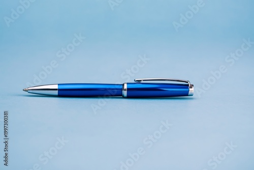 Blue Pen Placed on a Light Blue Background in a Simple Setting