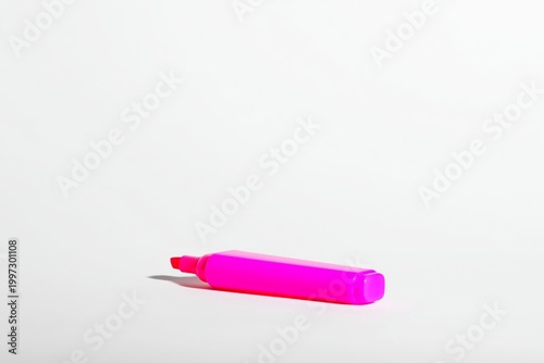 Bright Pink Highlighter on a Blank Surface Surrounded by Flowers at a Study Area