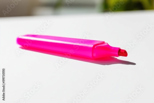 Bright Pink Highlighter on a Blank Surface Surrounded by Flowers at a Study Area