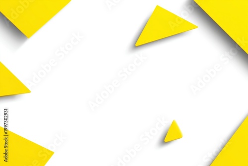 Bright Yellow Geometric Shapes Scattered on a White Surface in an Art Project