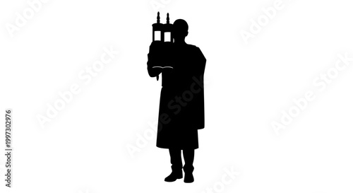 Silhouette of a Rabbi Holding a Torah Scroll in Prayer.