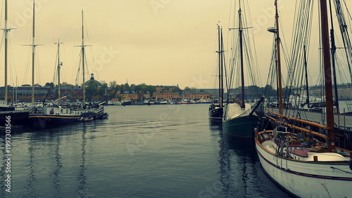 Canvas Print STOCKHOLM, SWEDEN - October 07, 2014: Traditional wooden sailing boats moored in the Stockholm harbor under an overcast sky