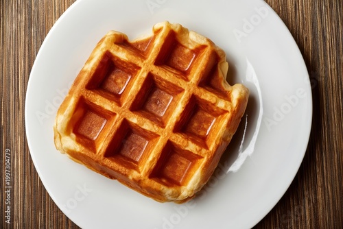 Waffle Served on a White Plate With a Plain Background in a Kitchen Setting