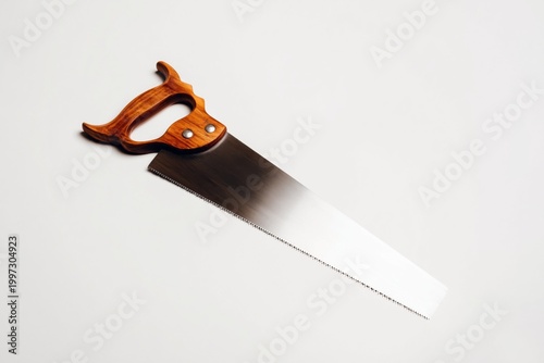 Wood Saw With a Wooden Handle Hanging Against a Plain Background