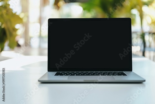 Blank Laptop Screen on a Table With Flowers in the Background During Daylight