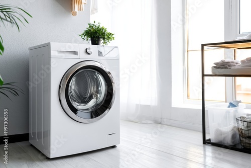 Washing Machine in Home Setting With Clothes Drying on a Rack Nearby in Brigh...