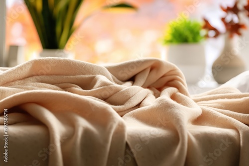 Cozy Blanket Rests on Bed in Sunlight During Morning Hours