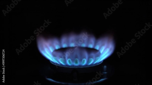 Close-up of a blue gas flame burning on a black background