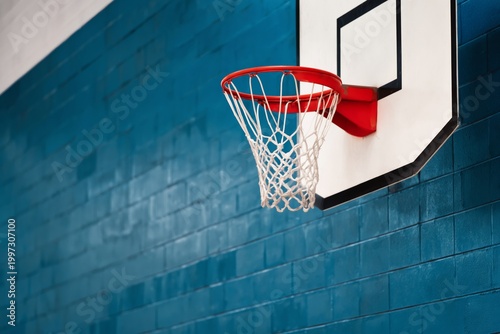 Basketball Hoop Hanging Near the Court in a Gym During a Daytime Practice Ses...