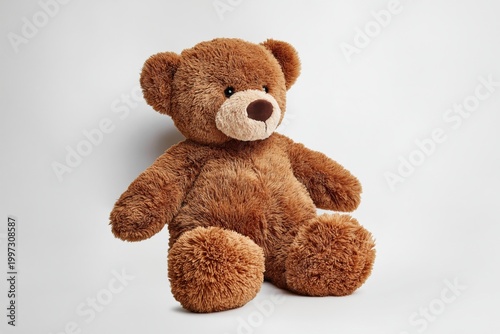 Soft Teddy Bear Sitting on a Plain Background in a Well-Lit Room During Daytime
